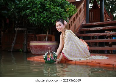 Portrait Beautiful Young Asia Woman With Traditional Thai Costume Hold Banana Leaf Cockerel Or Kra Thong In Thai , Loy Krathong Festival On November