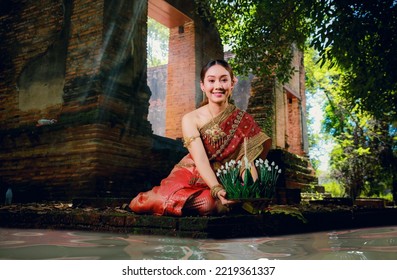 Portrait Beautiful Young Asia Woman With Traditional Thai Costume Hold Banana Leaf Cockerel Or Kra Thong In Thai , Loy Krathong Festival On November