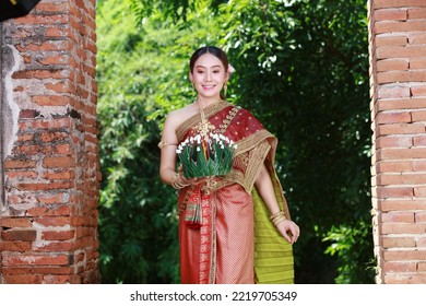 Portrait Beautiful Young Asia Woman With Traditional Thai Costume Hold Banana Leaf Cockerel Or Kra Thong In Thai , Loy Krathong Festival On November