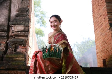 Portrait Beautiful Young Asia Woman With Traditional Thai Costume Hold Banana Leaf Cockerel Or Kra Thong In Thai , Loy Krathong Festival On November