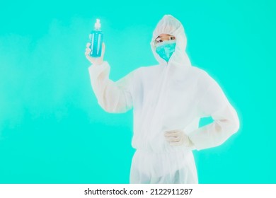 Portrait Beautiful Young Asian Doctor Woman Wear Ppe Suite And Mask With Alcohol Gel On Blue Isolated Background