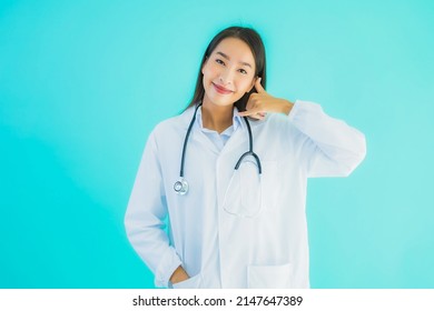 Portrait Beautiful Young Asian Doctor Woman Use Mobile Smart Cell Phone For Clinic Or Hospital On Blue Isolated Background