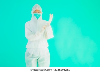 Portrait Beautiful Young Asian Doctor Woman Wear Ppe Or  Personal Protective Equipment For Protect From Coronavirus Or Covid19 On Blue Isolated Background