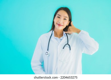 Portrait Beautiful Young Asian Doctor Woman Use Mobile Smart Cell Phone For Clinic Or Hospital On Blue Isolated Background