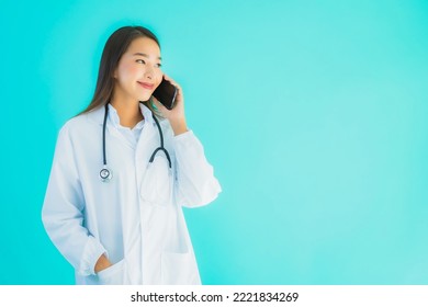 Portrait Beautiful Young Asian Doctor Woman Use Mobile Smart Cell Phone For Clinic Or Hospital On Blue Isolated Background