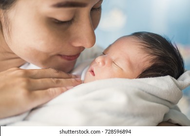 Portrait Of Beautiful Young Asian Mother With Her New Born Baby, Copy Space With Bed In The Hospital Background. Single Mom And Mother's Day Concept