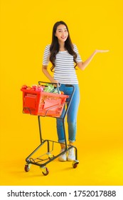 Portrait Beautiful Young Asian Woman Shopping Grocery From Supermarket And Cart On Yellow Isolated Background