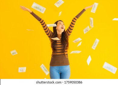 Portrait Beautiful Young Asian Woman Happy Smile And Rich With A Lot Of Cash In Her Hand On Yellow Isolated Background