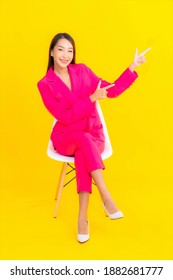Portrait beautiful young asian woman smile in action on yellow color background - Shutterstock ID 1882681777