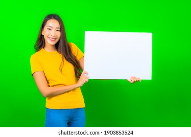 Portrait beautiful young asian woman show white empty billboard on green color background
