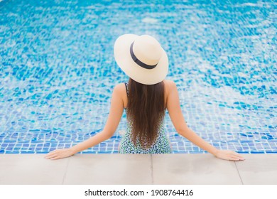 Portrait beautiful young asian woman relax smile leisure around outdoor swimming pool in holiday vacation travel trips - Shutterstock ID 1908764416