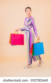 Portrait Beautiful Young Asian Woman With Colorful Shopping Bag On Color Isolated Background