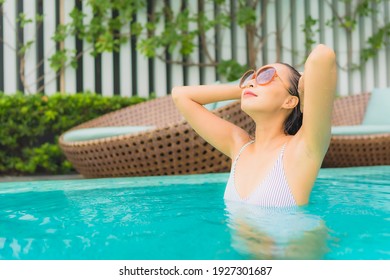 Portrait beautiful young asian woman relax leisure around outdoor swimming pool in hotel resort for travel vacation