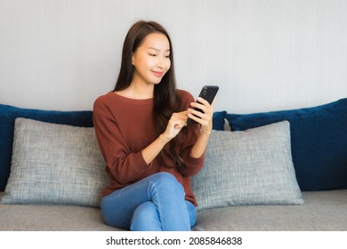 Portrait beautiful young asian woman use smart phone on sofa in living room interior - Shutterstock ID 2085846838