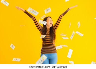 Portrait Beautiful Young Asian Woman Happy Smile And Rich With A Lot Of Cash In Her Hand On Yellow Isolated Background