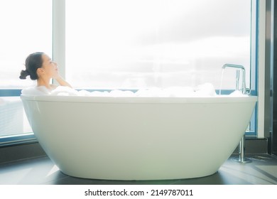 Portrait beautiful young asian woman relax enjoy in bathtub in bathroom interior - Powered by Shutterstock