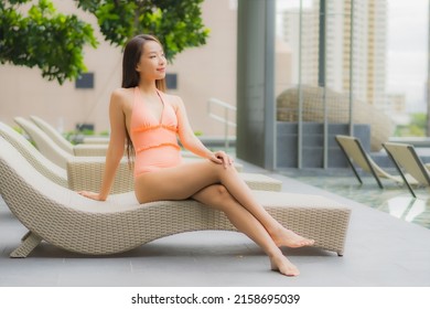 Portrait beautiful young asian woman relax smile leisure around outdoor swimming pool in hotel resort - Shutterstock ID 2158695039
