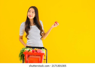 Portrait Beautiful Young Asian Woman Shopping Grocery From Supermarket And Cart On Yellow Isolated Background