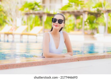 Portrait beautiful young asian woman relax smile leisure around outdoor swimming pool in hotel resort on vacation travel - Shutterstock ID 2177446693