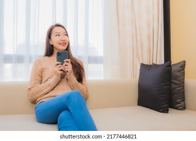 Portrait beautiful young asian woman relax smile happy with smart phone with coffee on sofa - Shutterstock ID 2177446821