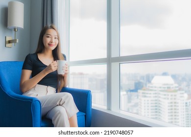 Portrait Beautiful Young Asian Woman Hold Coffee Cup On Sofa Chair In Living Room Area