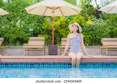 Portrait beautiful young asian woman relax smile leisure around outdoor swimming pool in holiday vacation travel trips - Shutterstock ID 2194343409