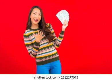 Portrait Beautiful Young Asian Woman With Cash Money And Mobile Phone On Red Background