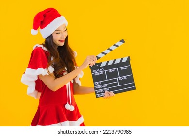 Portrait Beautiful Young Asian Woman Wear Christmas Clothes And Hat Show Movie Scene Cutter Plate On Yellow Isolated Background