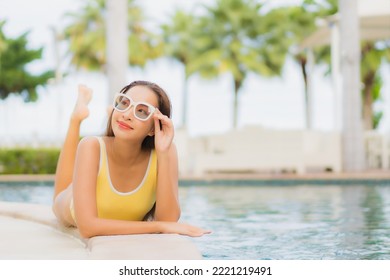 Portrait beautiful young asian woman relax smile leisure around outdoor swimming pool in holiday vacation travel trips - Shutterstock ID 2221219491