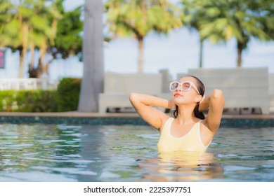 Portrait beautiful young asian woman relax smile leisure around outdoor swimming pool in holiday vacation travel trips - Shutterstock ID 2225397751