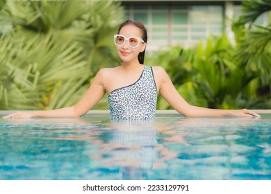 Portrait beautiful young asian woman relax smile leisure around outdoor swimming pool in holiday vacation travel trips - Shutterstock ID 2233129791