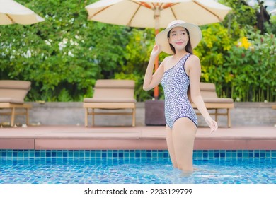 Portrait beautiful young asian woman relax smile leisure around outdoor swimming pool in holiday vacation travel trips - Shutterstock ID 2233129799