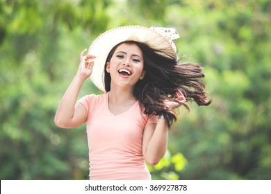 A Portrait Of A Beautiful Young Asian Woman Wearing Round Hat On A Park