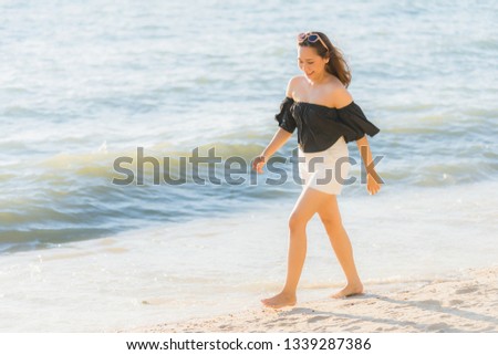 Portrait beautiful young asian woman happy and smile on the beach sea and ocean for travel and vacation concept