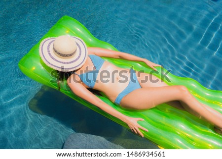 Portrait beautiful young asian woman smile happy relax and leisure on the rubber floating inflatable around the swimming pool hotel resort for travel and vacation concept