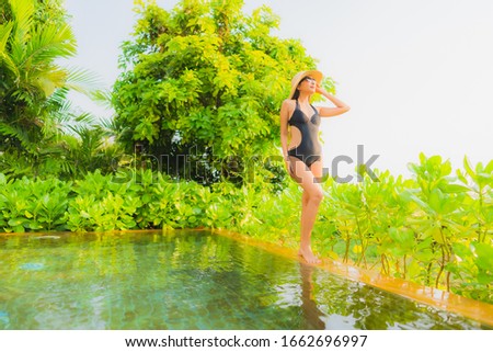 Portrait beautiful young asian woman   relax in swimming pool at hotel resort for leisure vacation trip