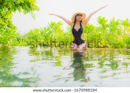 Portrait beautiful young asian woman   relax in swimming pool at hotel resort for leisure vacation trip