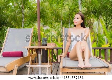 Portrait beautiful young asian woman smile relax around outdoor swimming pool in resort hotel on holiday vacation travel trip