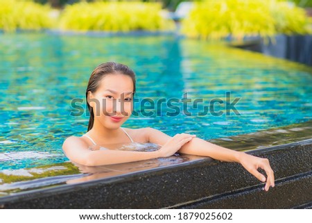 Portrait beautiful young asian woman relax smile leisure around outdoor swimming pool nearly sea beach ocean for holiday vacation