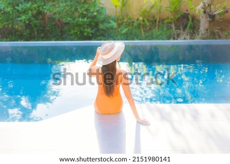 Portrait beautiful young asian woman enjoy relax around swimming pool for leisure vacation