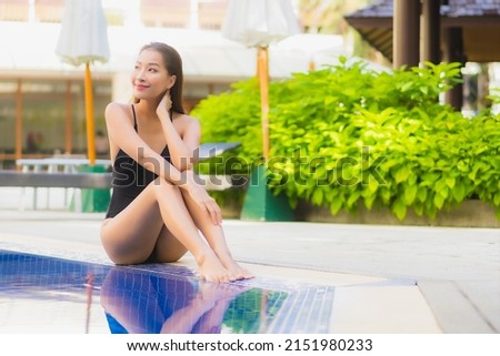 Portrait beautiful young asian woman smile relax leisure around outdoor swimming pool in hotel resort