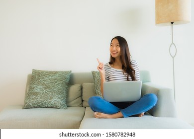 Portrait beautiful young asian women using laptop or computer on sofa in living room interior - Shutterstock ID 1580782948