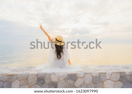 Portrait beautiful young asian women happy smile relax around sea beach ocean at sunrise or sunset time