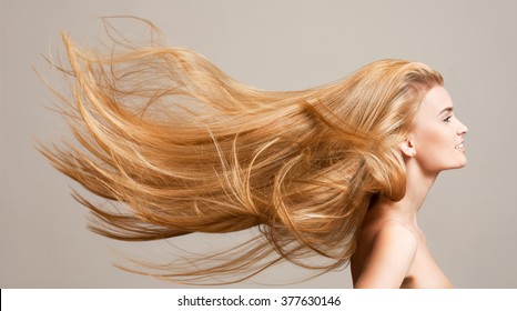 Portrait of a beautiful young blond woman with amazing flowing hair.
