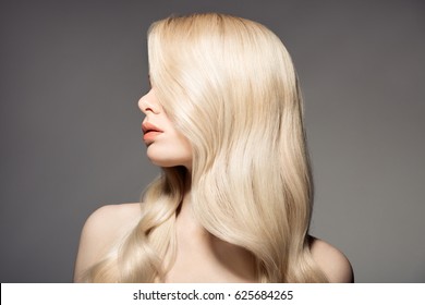 Portrait Of Beautiful Young Blond Woman With Long Wavy Hair. 