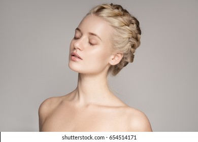 Portrait Of Beautiful Young Blond Woman With Braid Crown Hairstyle.