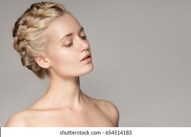 Portrait Of Beautiful Young Blond Woman With Braid Crown Hairstyle.