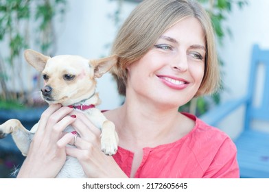 portrait beautiful young blonde smiling and pet dog Chihuahua