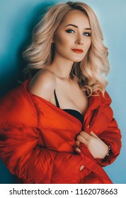 Portrait of beautiful young blonde woman with makeup in fashion clothes