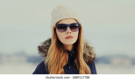 Portrait of beautiful young blonde woman wearing a hat outdoors